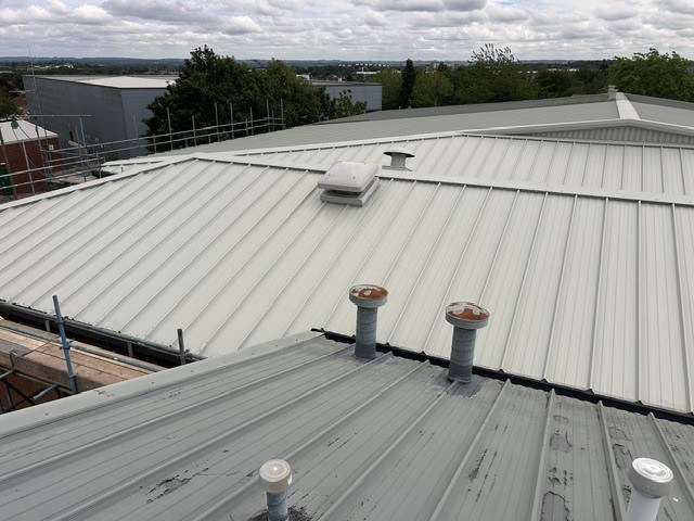 Deteriorated roof and gutters across both retail units before refurbishment